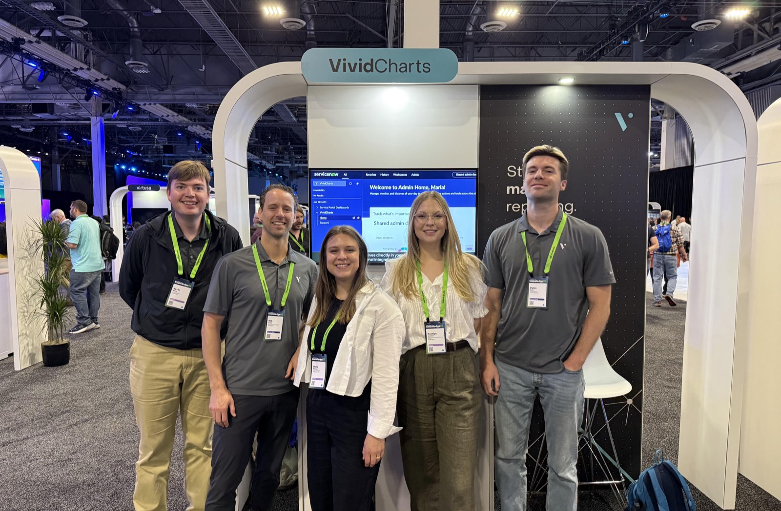 Five members of the VividCharts team standing together at their event booth